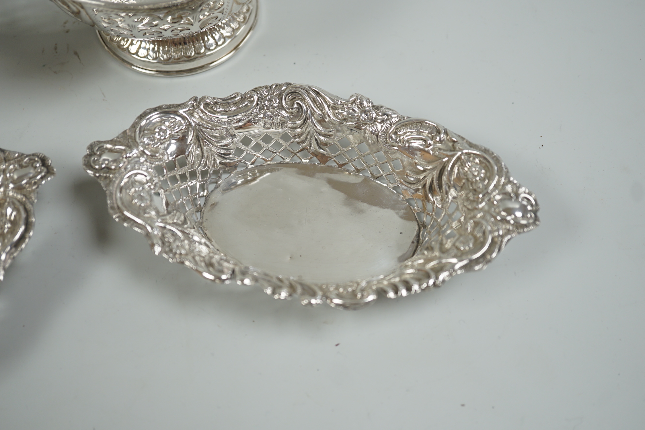 A modern pair of pierced silver circular bowls, by C.J. Vander Ltd, diameter 10.8cm and a pair of late Victorian silver bonbon dishes, 10oz.